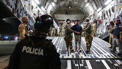 U.S. military personnel escort alleged members of the Venezuelan gang Tren de Aragua and the MS-13 gang recently deported by the U.S. government to be imprisoned in the Terrorism Confinement Center (CECOT) prison, at the El Salvador International Airport in San Luis Talpa, El Salvador April 12, 2025. (Reuters)