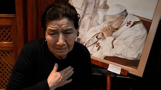 A faithful Catholic reacts while praying in front of a painting depicting Pope Francis at the Basilica San Jose de Flores in Buenos Aires on April 21, 2025, following the death of Pope Francis in the Vatican. The Basilica de San Jose de Flores was the church where Pope Francis was inspired to consecrate his life to God and the Catholic Church. Pope Francis died on April 21, 2025 aged 88, a day after making a much hoped-for appearance at Saint Peter's Square on Easter Sunday, the Vatican said in a statement. (Photo by Luis ROBAYO / AFP)(AFP)