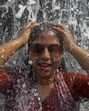 A tourist enjoys at the waterfall on a hot summer day, at Rock Garden in Chandigarhon Monday. (PTI) A tourist enjoys at the waterfall on a hot summer day, at Rock Garden in Chandigarhon Monday. (PTI)
