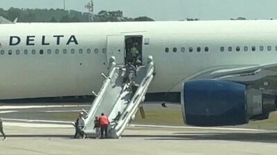 People evacuate a Delta plane due to an engine fire in Orlando, Florida, United States, April 21, 2025, in this video screengrab obtained from social media. (via REUTERS)