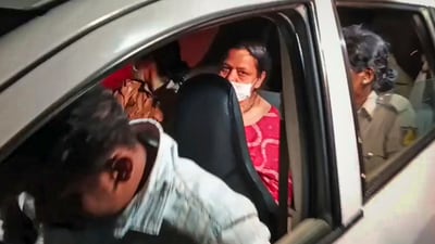 Police personnel take wife of former Karnataka DGP Om Prakash after her arrest in the Ex-DGP murder case, in Bengaluru. (PTI)