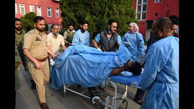 Paramedics carry an injured tourist to a hospital in Anantnag on Tuesday. (Waseem Andrabi /HT)