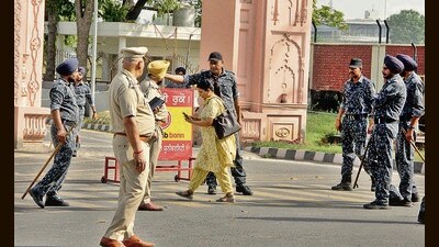 Police personnel deployed outside the Punjab Agricultural University on Tuesday; and (right) police detaining members of PAU employees’ union. (Gurpreet Singh/HT) Police personnel deployed outside the Punjab Agricultural University on Tuesday; and (right) police detaining members of PAU employees’ union. (Gurpreet Singh/HT)