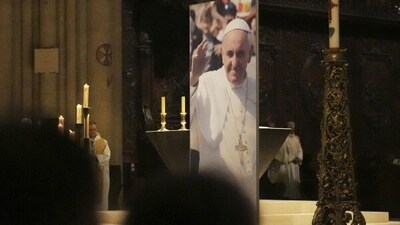 People attend a ceremony inside Notre Dame cathedral where a poster shows Pope Francis following the Vatican’s announcement of his death, Monday, April 21, 2025 in Paris. (AP Photo/Thibault Camus) People attend a ceremony inside Notre Dame cathedral where a poster shows Pope Francis following the Vatican’s announcement of his death, Monday, April 21, 2025 in Paris. (AP Photo/Thibault Camus)