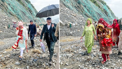 Newly wed Groom (L) and Bride (R) walk on a road covered with debris following a landslide triggered by heavy rains and hailstorm, in Ramban on Monday. (ANI) Newly wed Groom (L) and Bride (R) walk on a road covered with debris following a landslide triggered by heavy rains and hailstorm, in Ramban on Monday. (ANI)
