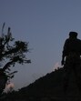 An Indian security officer stands guard in south Kashmir on Tuesday. (AP Photo)