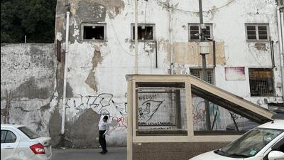 A massive facade is pockmarked with broken windows; one is choked up with bricks. While in another block, a shuttered shopfront is standing profoundly forlorn. (HT Photo) A massive facade is pockmarked with broken windows; one is choked up with bricks. While in another block, a shuttered shopfront is standing profoundly forlorn. (HT Photo)