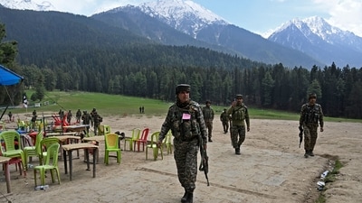Security personnel inspect the site in the aftermath of an attack as food stall chairs lie empty in Pahalgam on April 23, 2025. (AFP) Security personnel inspect the site in the aftermath of an attack as food stall chairs lie empty in Pahalgam on April 23, 2025. (AFP)