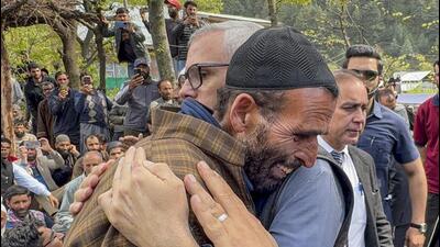 Jammu and Kashmir chief minister Omar Abdullah consoling the father of Syed Adil Hussain Shah, a pony ride operator who was killed in the terrorist attack in Pahalgam on Tuesday, in Anantnag district on Wednesday. (PTI Photo)