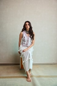 Outfit: Virgio | Jewellery: Shri Paramani Jewels | Palak is a vision in a white embroidered vest and ruffled midi skirt. It is complemented with a statement choker featuring intricate gemstone and gold work (Photo: Siddharth Jaiswar) Outfit: Virgio | Jewellery: Shri Paramani Jewels | Palak is a vision in a white embroidered vest and ruffled midi skirt. It is complemented with a statement choker featuring intricate gemstone and gold work (Photo: Siddharth Jaiswar)