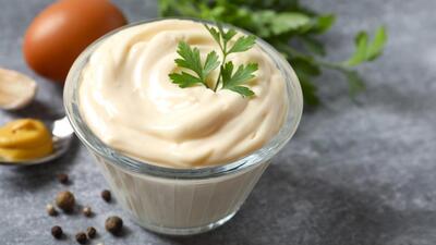 Bowl with mayonnaise and ingredients for cooking on gray background (Shutterstock) Bowl with mayonnaise and ingredients for cooking on gray background (Shutterstock)