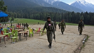 Security personnel inspect the site in the aftermath of an attack as food stall chairs lie empty in Pahalgam on April 23, 2025. (AFP) Security personnel inspect the site in the aftermath of an attack as food stall chairs lie empty in Pahalgam on April 23, 2025. (AFP)