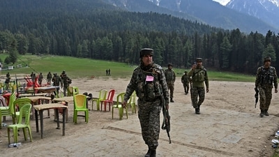 Security personnel inspect the site in the aftermath of an attack as food stall chairs lie empty in Pahalgam on April 23, 2025. (AFP) Security personnel inspect the site in the aftermath of an attack as food stall chairs lie empty in Pahalgam on April 23, 2025. (AFP)