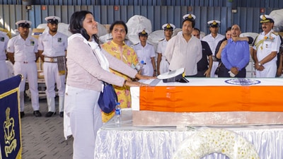 Indian Navy Lt. Vinay Narwal's wife breaks down while paying tribute to her husband after his mortal remains were brought at the cargo terminal of IGI Airport, in New Delhi, Wednesday, April 23, 2025. Narwal was killed in the Tuesday's Pahalgam terror attack. (PTI)