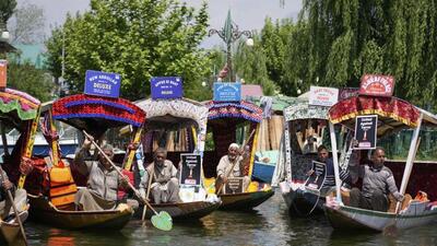 Shikara boatmen holding placards, distributed to them by a group of students, at Dal Lake in Srinagar on Thursday. They were protesting against the Pahalgam terror attack that left 26 tourists dead on Tuesday. (AFP Photo) Shikara boatmen holding placards, distributed to them by a group of students, at Dal Lake in Srinagar on Thursday. They were protesting against the Pahalgam terror attack that left 26 tourists dead on Tuesday. (AFP Photo)