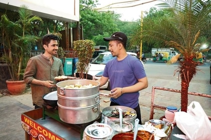 The actor digs into a plate of steaming hot momos at SDA market. (Photo: Raajessh Kashyap/HT) The actor digs into a plate of steaming hot momos at SDA market. (Photo: Raajessh Kashyap/HT)