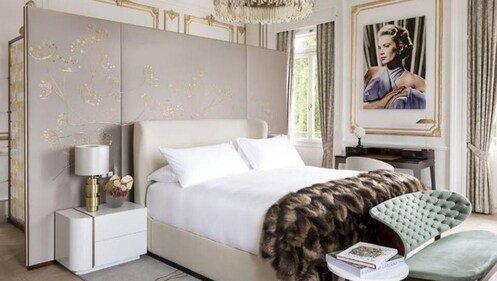 The Grace Kelly suite includes a master bedroom, living room, kitchenette and dining room, all decorated in the art deco style with gold details and accented with high ceilings and plenty of natural light (Photo courtesy: ritzcarlton.com)
