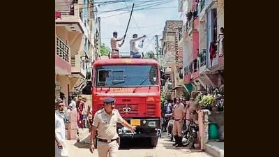Firefighters had to wait for power supply to be snapped by electricity department before moving forward by lifting the wires, delaying emergency response. (HT Photo) Firefighters had to wait for power supply to be snapped by electricity department before moving forward by lifting the wires, delaying emergency response. (HT Photo)