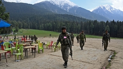 Security personnel inspect the site in the aftermath of the terror attack as food stall chairs lie empty in Pahalgam on April 23. (AFP) Security personnel inspect the site in the aftermath of the terror attack as food stall chairs lie empty in Pahalgam on April 23. (AFP)