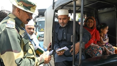 Indian BSF soldier check the passports of Pakistani citizens as they return to their country at the India-Pakistan Wagah border post on the outskirts of Amritsar on April 25,2025. New Delhi suspended a water-sharing treaty, announced the closure of the main land border crossing with Pakistan, downgraded diplomatic ties and withdrew visas for Pakistanis on April 23. just over 24 hours after gunmen killed 26 men in Indian-administered Kashmir. (Narinder Nanu/AFP) Indian BSF soldier check the passports of Pakistani citizens as they return to their country at the India-Pakistan Wagah border post on the outskirts of Amritsar on April 25,2025. New Delhi suspended a water-sharing treaty, announced the closure of the main land border crossing with Pakistan, downgraded diplomatic ties and withdrew visas for Pakistanis on April 23. just over 24 hours after gunmen killed 26 men in Indian-administered Kashmir. (Narinder Nanu/AFP)