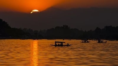 Tourists taking a ‘shikara’ ride are silhouetted against the setting Sun at the Dal Lake, in Srinagar (PTI)