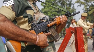 Kathua: A BSF jawan guards as Jammu and Kashmir Police personnel check the vehicles on the Jammu-Srinagar highway after a truck was seized with arms and ammunition, in Kathua, Jammu, Thursday, Sept 12, 2019. (PTI) Kathua: A BSF jawan guards as Jammu and Kashmir Police personnel check the vehicles on the Jammu-Srinagar highway after a truck was seized with arms and ammunition, in Kathua, Jammu, Thursday, Sept 12, 2019. (PTI)