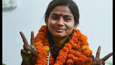UP Board Class 12 topper Mehak Jaiswal celebrates after the result, in Prayagraj, Friday. (PTI Photo)