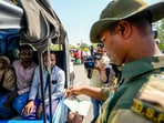 A BSF jawan checks documents of Pakistani nationals as they arrive at the Integrated Check Post at the Attari-Wagah border. A BSF jawan checks documents of Pakistani nationals as they arrive at the Integrated Check Post at the Attari-Wagah border.