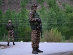Paramilitary soldiers stand guard near Pahalgam on April 22, 2025.
