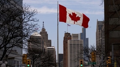 A Canadian flag flies in front of the Detroit skyline in downtown Windsor, Ontario, Canada. (Bloomberg) A Canadian flag flies in front of the Detroit skyline in downtown Windsor, Ontario, Canada. (Bloomberg)