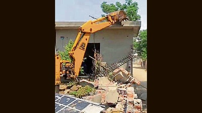 A drug smuggler’s house being razed at Daulewala village in Moga on Saturday. (HT Photo)