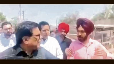 A grab of the viral video that showed a city resident (right) asking MLA Madan Lal Bagga to drink water from a bottle he had. (HT Photo) A grab of the viral video that showed a city resident (right) asking MLA Madan Lal Bagga to drink water from a bottle he had. (HT Photo)