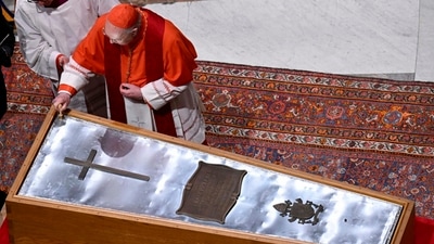 Cardianal Camerlengo Kevin Joseph Farrel seals the zinc cover of the casket containing the body of late Pope Francis in St. Peter's Basilica at the Vatican on Friday. (AP)