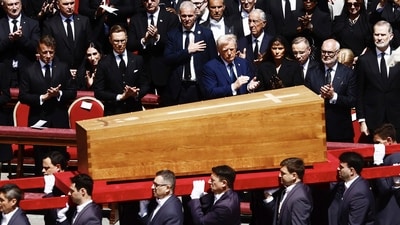 President Donald Trump, center, pays respect at the coffin of Pope Francis while being carried in front of dignitaries during his funeral in St. Peter's Square at the Vatican, Saturday, April 26, 2025. AP/PTI(AP04_26_2025_000214B) (AP) President Donald Trump, center, pays respect at the coffin of Pope Francis while being carried in front of dignitaries during his funeral in St. Peter's Square at the Vatican, Saturday, April 26, 2025. AP/PTI(AP04_26_2025_000214B) (AP)