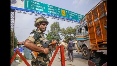 Kathua: A BSF jawan guards as Jammu and Kashmir Police personnel check the vehicles on the Jammu-Srinagar highway after a truck was seized with arms and ammunition, in Kathua, Jammu, Thursday, Sept 12, 2019. (PTI) Kathua: A BSF jawan guards as Jammu and Kashmir Police personnel check the vehicles on the Jammu-Srinagar highway after a truck was seized with arms and ammunition, in Kathua, Jammu, Thursday, Sept 12, 2019. (PTI)