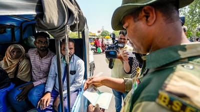 A BSF jawan checks documents of Pakistani nationals as they arrive at the Integrated Check Post at the Attari-Wagah border. (PTI) A BSF jawan checks documents of Pakistani nationals as they arrive at the Integrated Check Post at the Attari-Wagah border. (PTI)