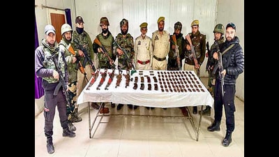 Security personnel show the recovered arms and ammunition in a joint operation by the Special Operation Group (SOG) and Indian Army's 12 SIKHLI unit, at Machil in Kupwara on Saturday. (ANI)