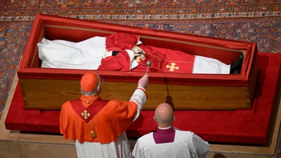 Cardianal Camerlengo Kevin Joseph Farrel asperges the body of late Pope Francis with holy water before closing his casket in St. Peter's Basilica at the Vatican on Friday, April 25, 2025. (AP) Cardianal Camerlengo Kevin Joseph Farrel asperges the body of late Pope Francis with holy water before closing his casket in St. Peter's Basilica at the Vatican on Friday, April 25, 2025. (AP)