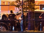 Vancouver police examine a black car suspected to be involved at a scene after a vehicle drove into a crowd at the Lapu Lapu Festival in Vancouver, British Columbia, Saturday April 26, 2025. (Rich Lam/The Canadian Press via AP)