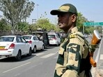 A Border Security Force (BSF) personnel stands guard as Pakistani citizens return to their country through the India-Pakistan Attari-Wagah border post.