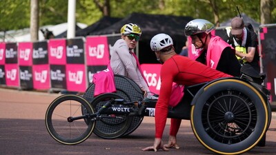 Marcel Hug of Switzerland, right, winner of the men's wheelchair race and Jetze Plat of the Netherland's who placed third in the men's race speak to Catherine Debrunner of Switzerland who won the women's wheelchair race near the finish line at the London Marathon, Sunday, April 27, 2025. (AP Photo/Alberto Pezzali) (AP) Marcel Hug of Switzerland, right, winner of the men's wheelchair race and Jetze Plat of the Netherland's who placed third in the men's race speak to Catherine Debrunner of Switzerland who won the women's wheelchair race near the finish line at the London Marathon, Sunday, April 27, 2025. (AP Photo/Alberto Pezzali) (AP)