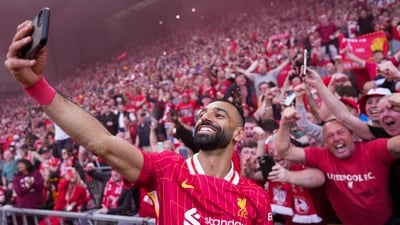 Liverpool's Mohamed Salah celebrates by taking a selfie after winning the English Premier League and clinching the Premier League title at Anfield in Liverpool, England, Sunday, April 27, 2025.&nbsp; (AP)