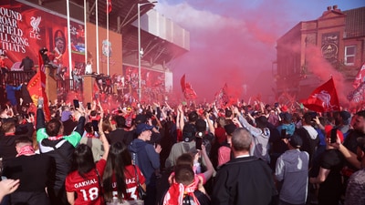 Liverpool fans celebrate outside the stadium after winning the Premier League. (Reuters)