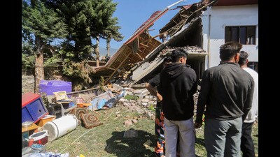 People near the debris of the house of terrorist Jameel Ahmed, that was demolished amid a crackdown on the terror ecosystem in the aftermath of the Pahalgam terror attack, in Bandipora district of J&K, on Sunday. (PTI) People near the debris of the house of terrorist Jameel Ahmed, that was demolished amid a crackdown on the terror ecosystem in the aftermath of the Pahalgam terror attack, in Bandipora district of J&K, on Sunday. (PTI)