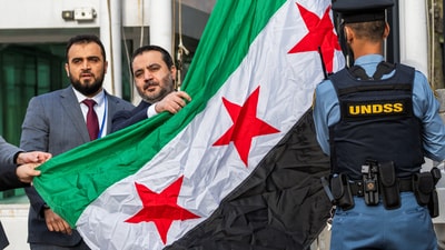 Syrian Foreign Minister Asaad Hassan al-Shibani attends the ceremony of the new Syrian government flag being raised for the first time, outside United Nations Headquarters in New York, U.S., April 25, 2025. (Reuters)