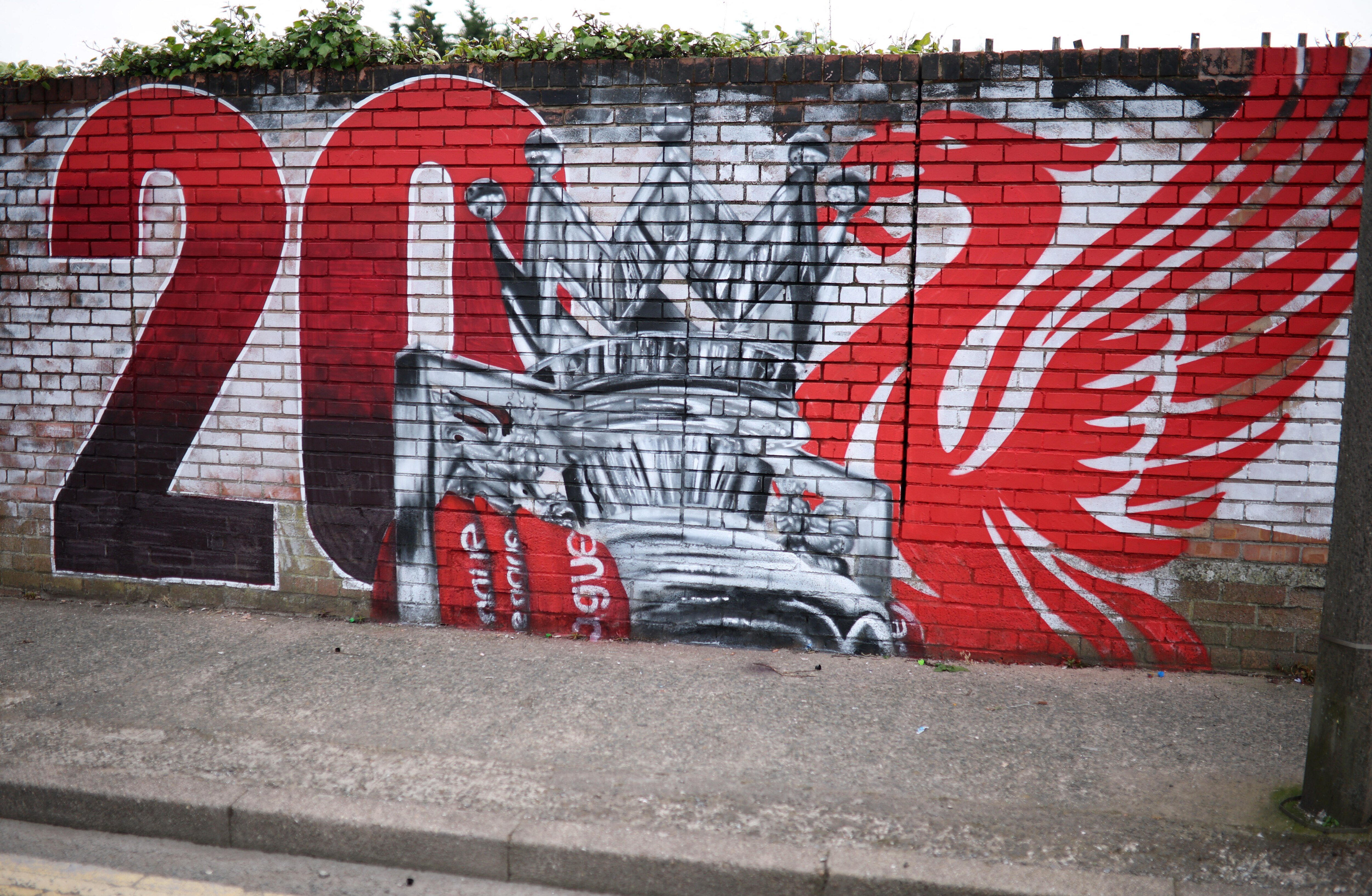 A mural is seen on a wall near Anfield ahead of Liverpool's match against Tottenham Hotspur on Sunday. A draw against Tottenham will crown them Premier League champions.  (REUTERS)