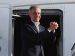 Canada's Prime Minister Mark Carney gestures ahead of his departure at Edmonton International Airport in Nisku, Alberta.