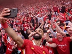 Mohamed Salah takes a selfie with fans.