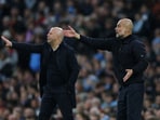 Liverpool manager Arne Slot and Manchester City manager Pep Guardiola during a match.
