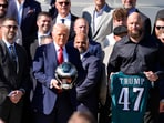Philadelphia Eagles head coach Nick Sirianni, left, and offensive tackle Lane Johnson stand next to President Donald Trump 